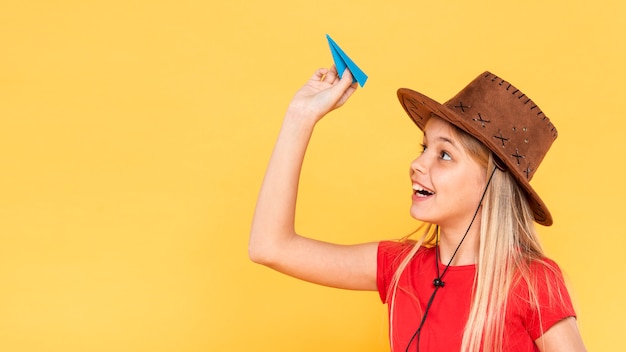 Side view girl with paper airplane