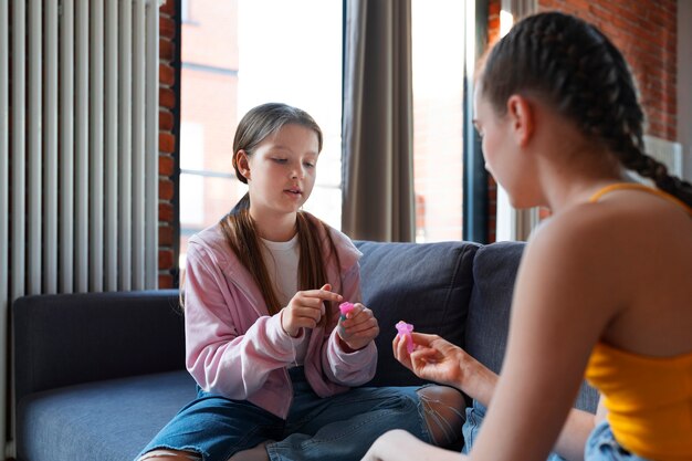 Side view girls holding menstrual cups