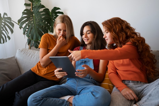 Foto gratuita ragazze di vista laterale che esaminano la compressa