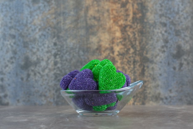 Free photo side view of glass bowl full of colorful candies.