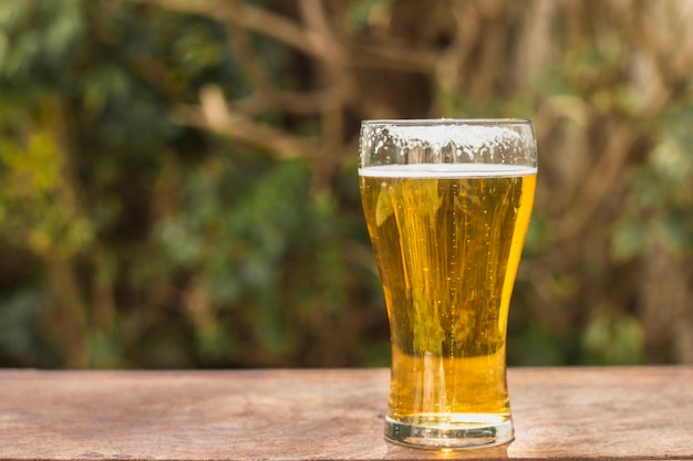 Side view glass with beer on table