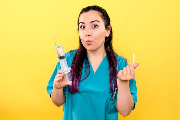 Side view of the good doctor with syringe makes an injection against covid