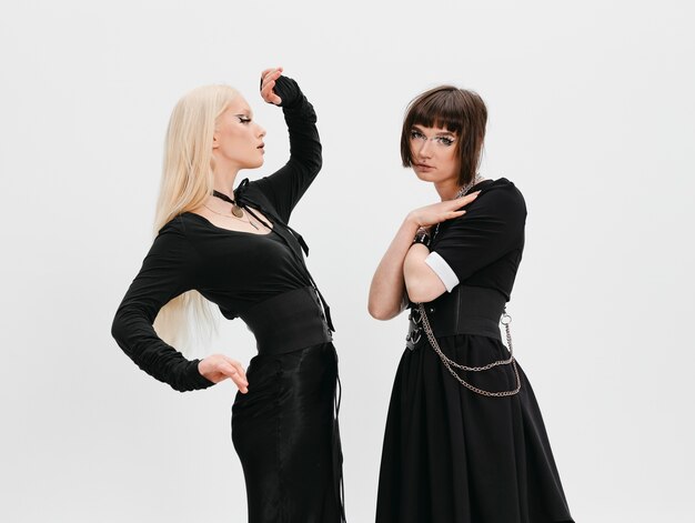 Side view goth girls posing in studio