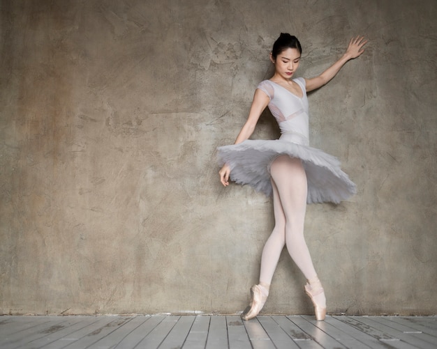Side view of gracious ballerina in tutu dress with copy space