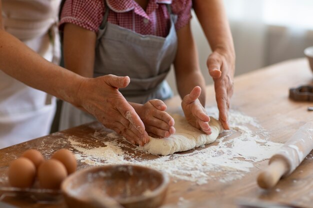 Side view grandma and girl cooking together