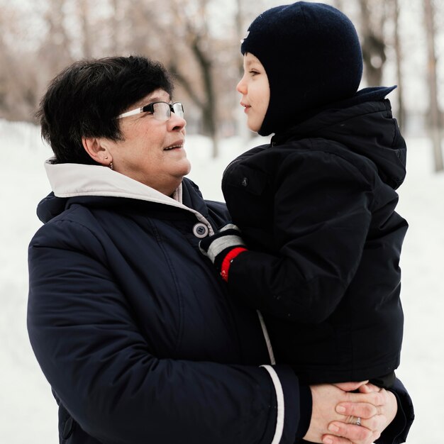 Side view of grandmother and grandson outdoors together