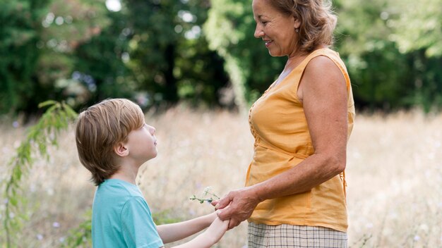 Side view grandmother and kid outdoors