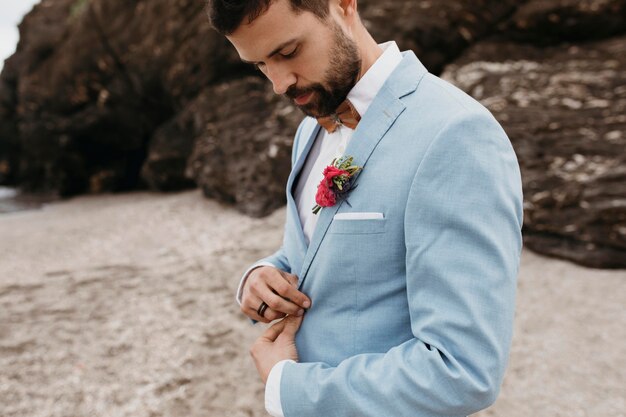 Side view groom in blue costume