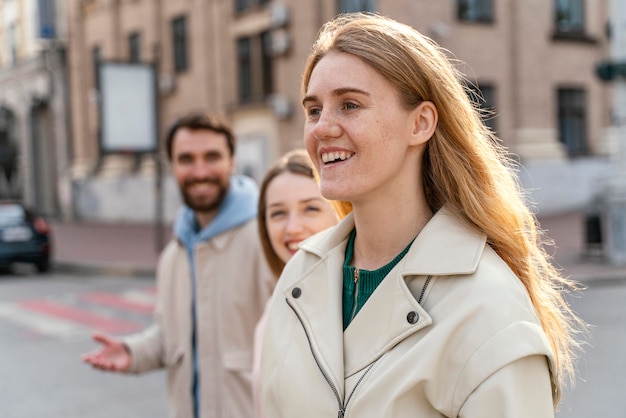 Side view of group of smiley friends outdoors in the city