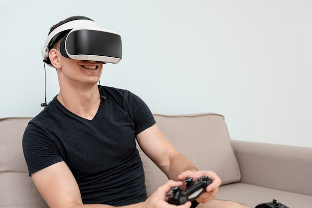 Side view guy with vr glasses and controller