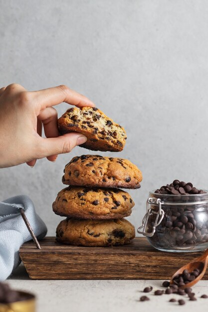 Side view hand holding chocolate chips cookie