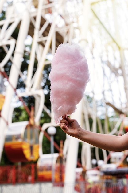 Free photo side view hand holding cotton candy