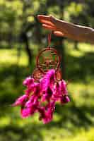 Free photo side view hand holding dream catcher