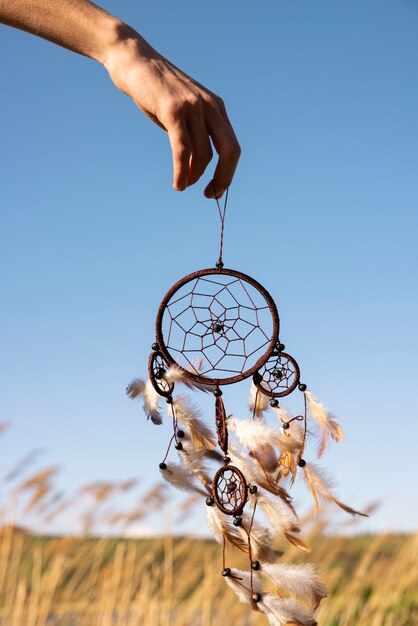 Side view hand holding dream catcher