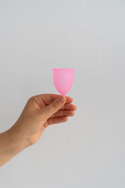 Бесплатное фото Вид сбоку рука с менструальной чашей