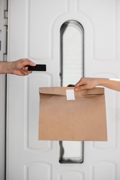 Side view hand holding paper bag