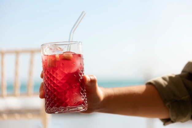 Side view hand holding sangria glass