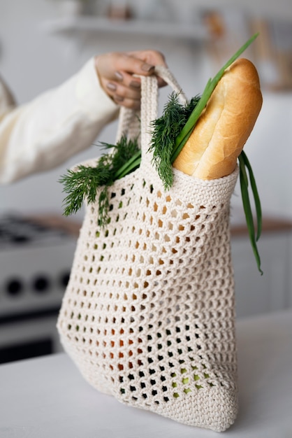 Side view hand holding tote bag