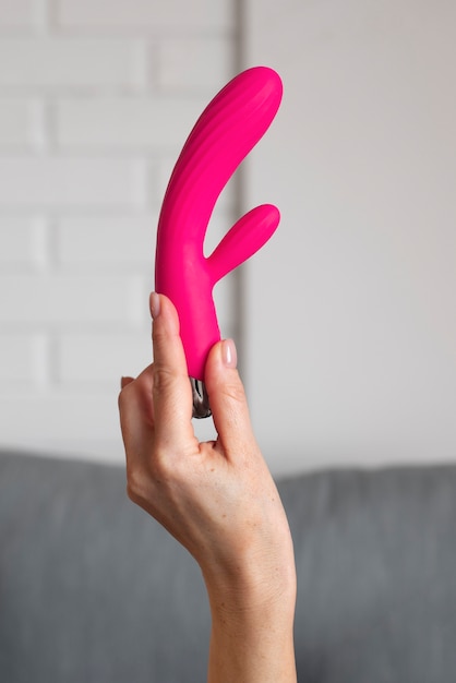 Free photo side view hand holding vibrator