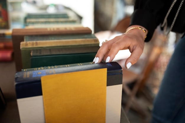 Free photo side view hand touching old book