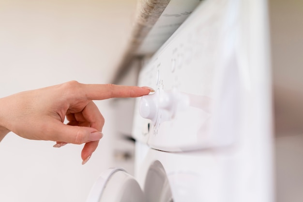 Side view hand touching washing machine