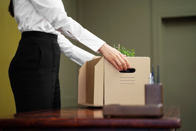 Side view hands holding cardboard box