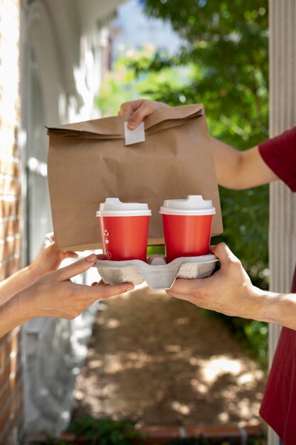 Side view hands holding coffee cups