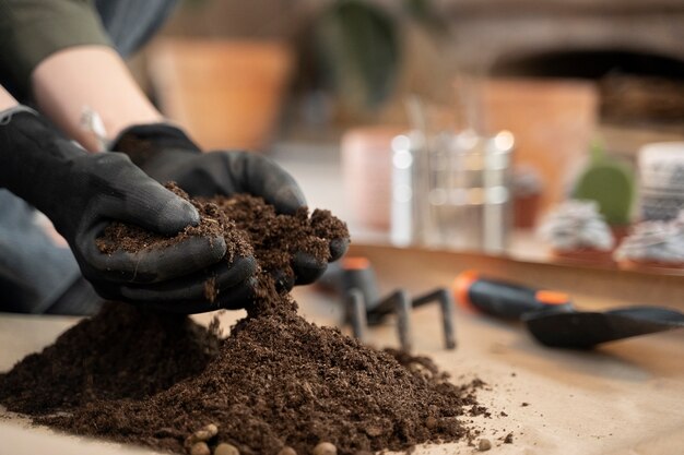 side view hands holding potting soil