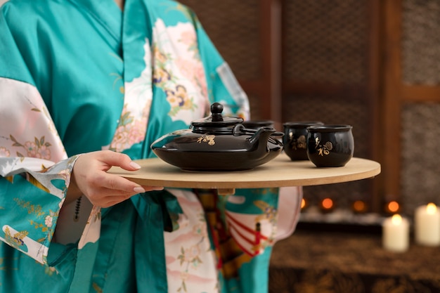 Side view hands holding wooden plate