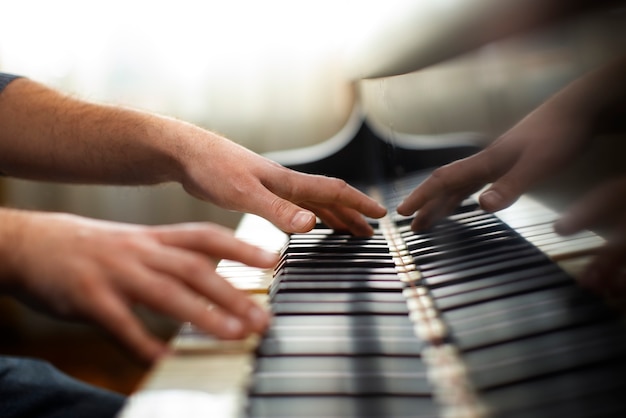 Free photo side view hands playing piano