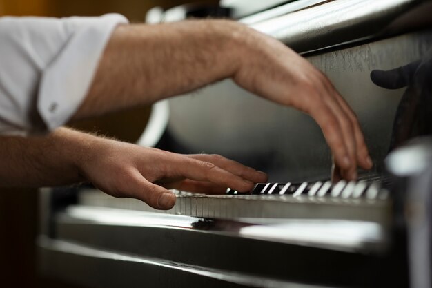 Side view hands playing piano