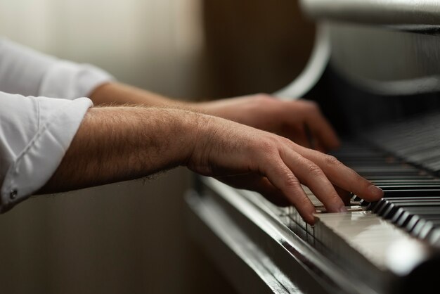 Side view hands playing piano