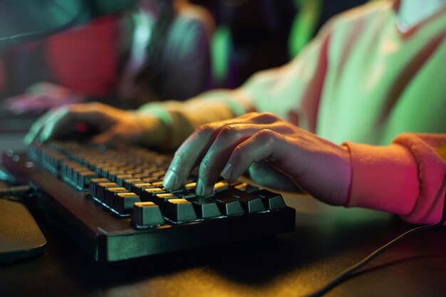 Side view hands typing on keyboard