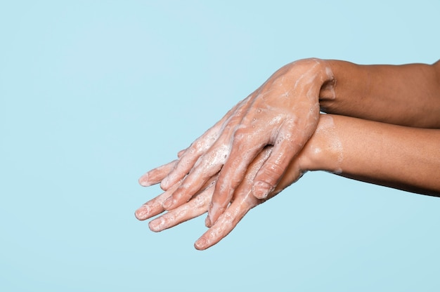 Side view hands washing with soap