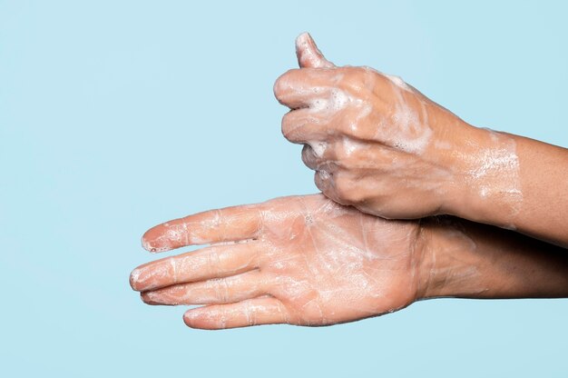 Side view hands washing with soap