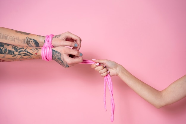 Side view hands wearing pink rope