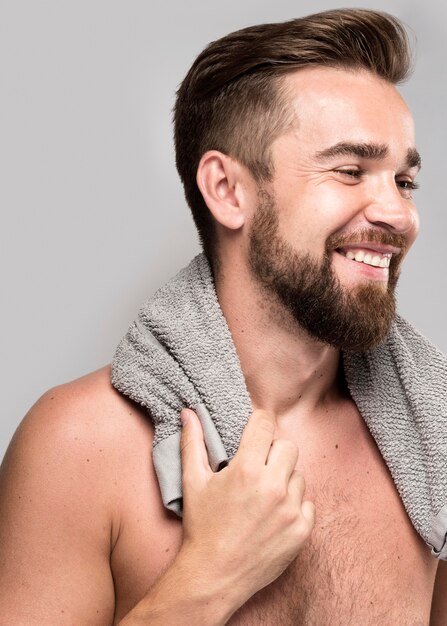 Side view handsome shirtless man smiling