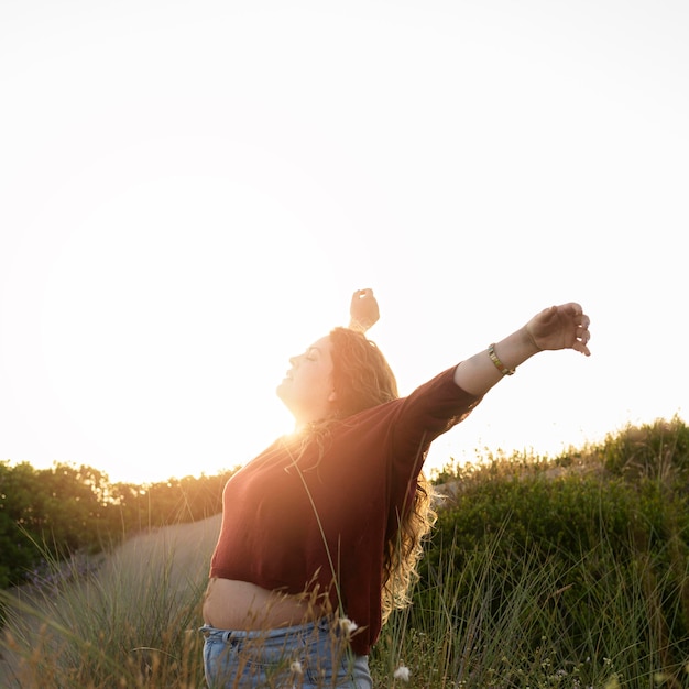 Side view of happy carefree woman in nature