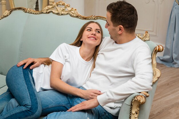 Side view of happy couple on couch