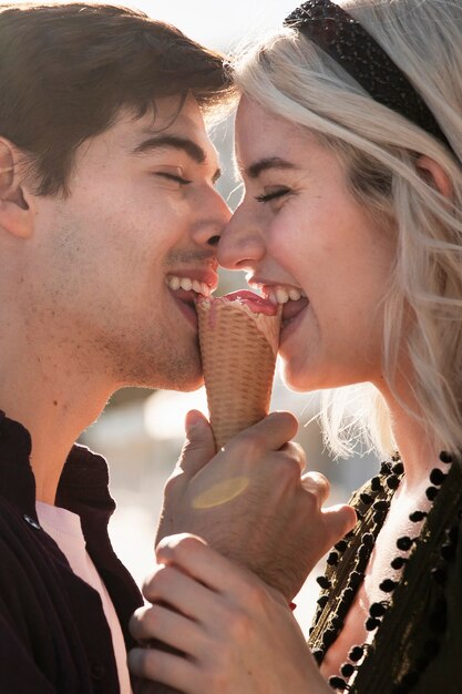 Side view of happy couple enjoying ice cream