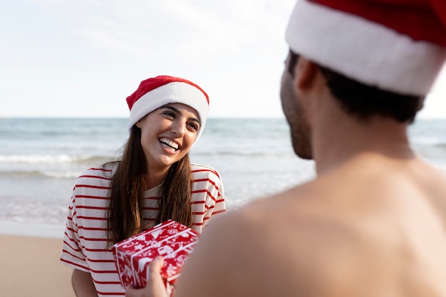 Free photo side view happy couple sharing gifts