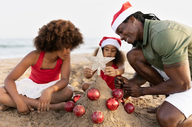 Side view happy family at beach decorating