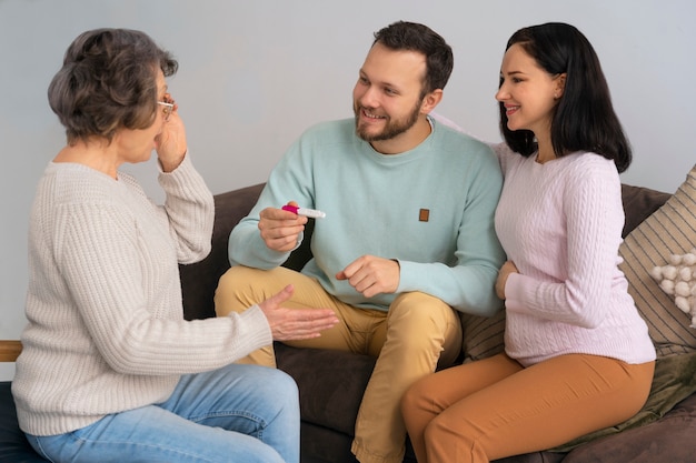 Free photo side view happy family expecting baby