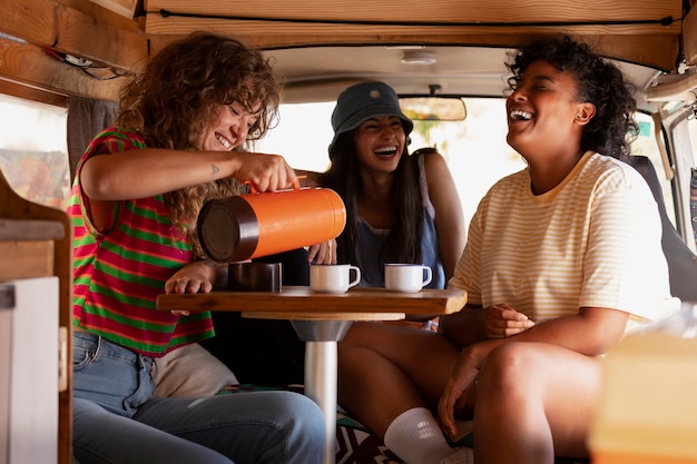 Side view happy friends in campervan