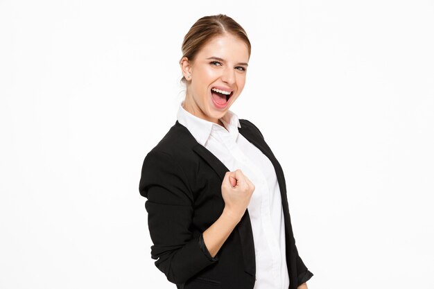 Side view of happy screaming blonde business woman  over white wall