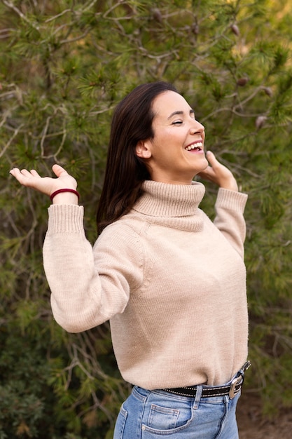 Free photo side view of happy woman in nature