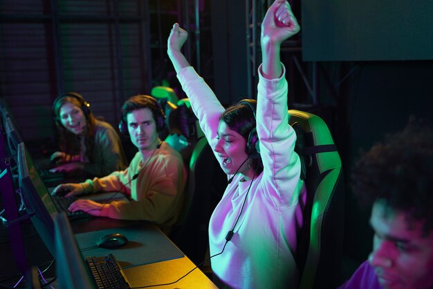 side view happy woman winning at videogame