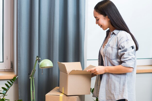 Side view of happy woman with online order arriving