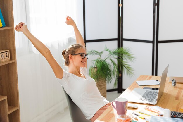 Side view of happy woman working at home