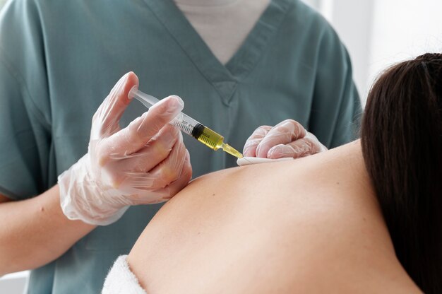 Side view healthcare professional injecting neck